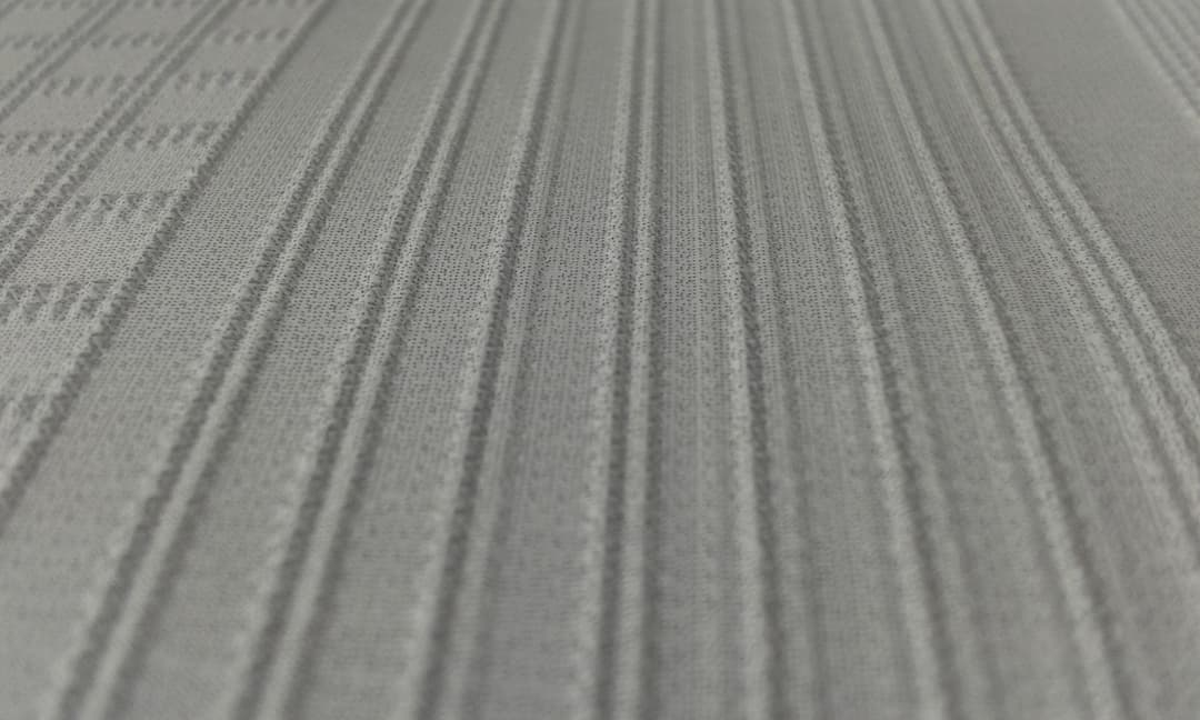 Lines of raised dots on top of a paper with ink printed on.