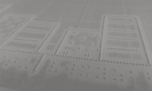 Paper with raised dots and gray printing around them, but not existent close to raised parts.