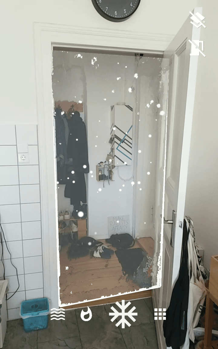 Doorframe with a portal inside and snow in the next room.